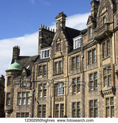 Stock Photograph - A large building with brown stone facade and many windows; Edinburgh, Scotland. Fotosearch