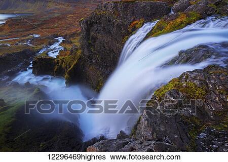 Stock Photograph - A large waterfall that is part of the Dynjand waterfall on the Westfjords; Iceland. Fotosearch