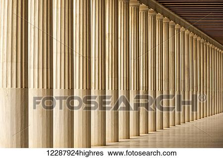 Stock Photograph - A long line of Doric pillars recedes into the distance in the Stoa of Attalos marble colonnade; Athens, Attica, Greece. Fotosearch