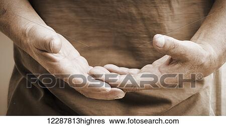 Stock Photograph - A man holding his hands out in front of him; Vernon, British Columbia, Canada. Fotosearch