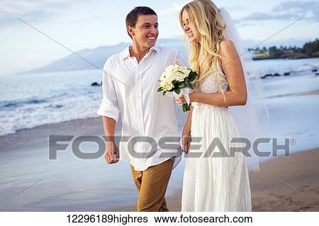 A married couple, bride and groom, at sunset on a beautiful tropical beach View Large Photo Image Stock Photograph - A married couple, bride and groom, at sunset on a beautiful tropical beach. Fotosearch
