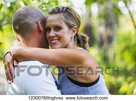 Stock Photograph - A married couple spending quality time together in a park during a family outing; Edmonton, Alberta, Canada. Fotosearch