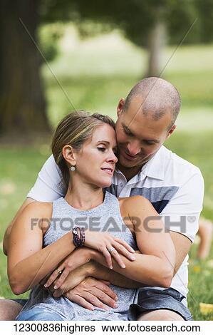 Stock Photograph - A married couple spending quality time together in a park; Edmonton, Alberta, Canada. Fotosearch
