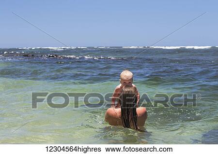 A mother and daughter play in the warm water; Kauai, Hawaii, United States of America View Large Photo Image Stock Photograph - A mother and daughter play in the warm water; Kauai, Hawaii, United States of America. Fotosearch