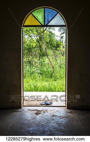 A pair of sandals left at the doorway of an orthodox church with a stained glass window overhead; Gulu, Uganda View Large Photo Image Stock Photograph - A pair of sandals left at the doorway of an orthodox church with a stained glass window overhead; Gulu, Uganda. Fotosearch