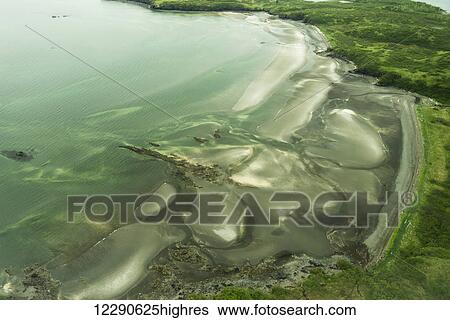 Stock Photograph - A patchwork of sand bars are exposed at low tide near Kukak Bay in Katmai National Park & Preserve, Alaska.. Fotosearch