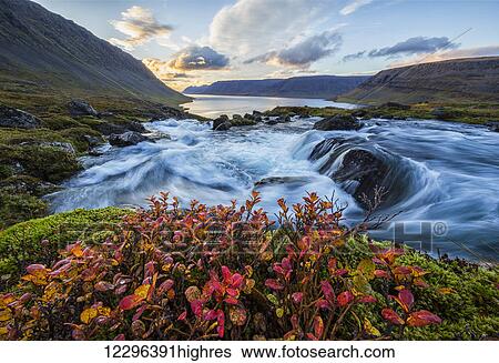Stock Photograph - A river flows through the landscape on the West Fjords; Iceland. Fotosearch