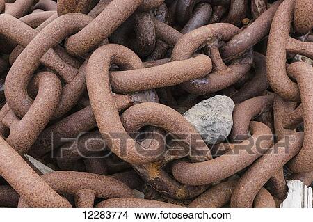 A rock sits on large rusty chain links, St. Paul Harbor, St. Paul Island, Southwestern Alaska, USA, Summer View Large Photo Image Picture - A rock sits on large rusty chain links, St. Paul Harbor, St. Paul Island, Southwestern Alaska, USA, Summer. Fotosearch