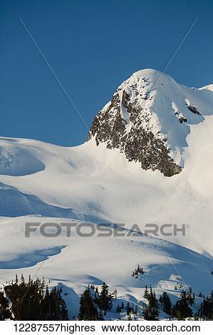 A rocky peak is blanketed in a fresh layer of snow, late afternoon light casting deep shadows on the landscape, Kings Bay, Prince William Sound; Whittier, Southcentral Alaska, United States of America View Large Photo Image Stock Photograph - A rocky peak is blanketed in a fresh layer of snow, late afternoon light casting deep shadows on the landscape, Kings Bay, Prince William Sound; Whittier, Southcentral Alaska, United States of America. Fotosearch