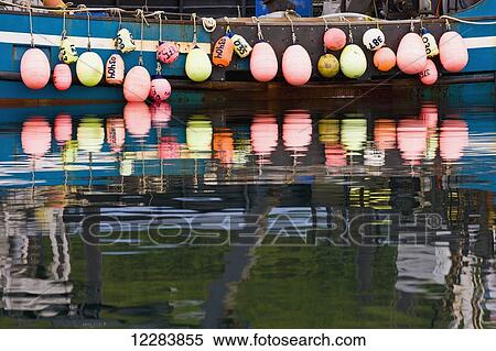 A row of multicolored buoys hang off the side of a blue fishing boat, Sand Point Harbor, Southwestern Alaska, USA, Summer View Large Photo Image Stock Photography - A row of multicolored buoys hang off the side of a blue fishing boat, Sand Point Harbor, Southwestern Alaska, USA, Summer . Fotosearch