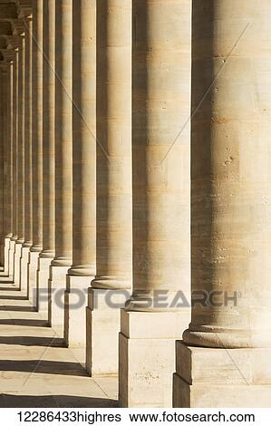 Stock Photograph - A row of pillars at Palais Royal form an interesting pattern; Paris, France. Fotosearch