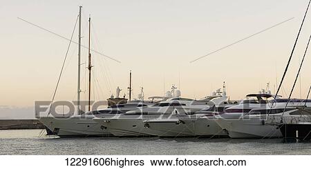A row of yachts moored in a harbour; Ischia, Italy View Large Photo Image Stock Photograph - A row of yachts moored in a harbour; Ischia, Italy. Fotosearch