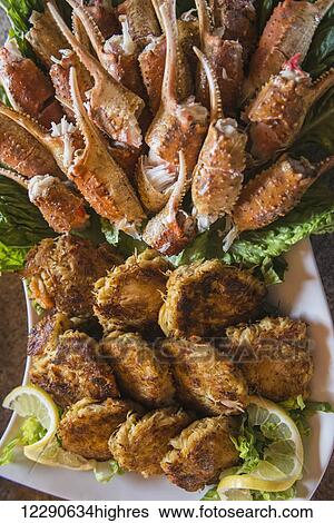 Stock Photograph - A sampling of crab claws and crab cakes awaits guests at the Katmai Wilderness Lodge in Kukak Bay, Katmai National Park & Preserve, Alaska.. Fotosearch