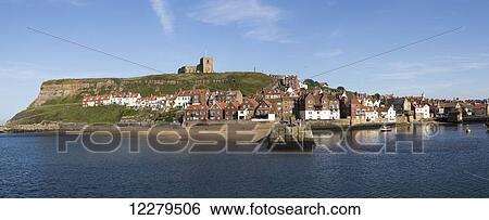 A seaside town and small harbour at the mouth of the River Esk; Whitby, Yorkshire, England View Large Photo Image Stock Photograph - A seaside town and small harbour at the mouth of the River Esk; Whitby, Yorkshire, England. Fotosearch