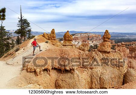 Stock Photograph - A senior man hikes in Bryce Canyon; Utah, United States of America. Fotosearch