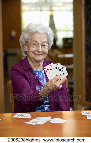A senior woman showing the cards in her hand; Edmonton, Alberta, Canada View Large Photo Image Stock Photograph - A senior woman showing the cards in her hand; Edmonton, Alberta, Canada. Fotosearch