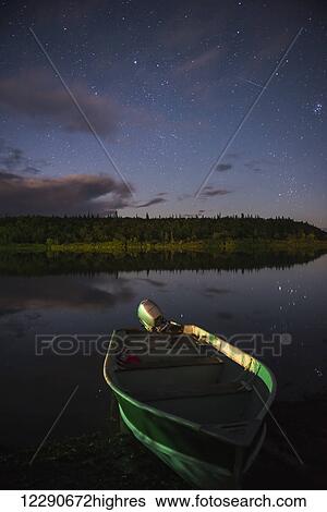 A skiff rests on the banks of the Kvichak River at night, Bristol Bay Region, Southwest Alaska. View Large Photo Image Stock Photograph - A skiff rests on the banks of the Kvichak River at night, Bristol Bay Region, Southwest Alaska.. Fotosearch
