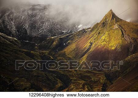 Stock Photograph - A spire of rock rises from the flanks of the volcano on the Snaefellsness Peninsula; Iceland. Fotosearch