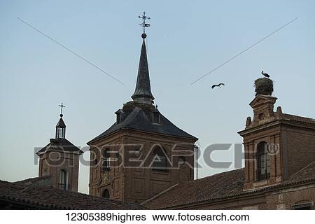 A stork flying around Archbishop's Palace in downtown Alcala de Henares, a historical and charming city near to Madrid; Alcala de Henares, Spain View Large Photo Image Stock Photograph - A stork flying around Archbishop's Palace in downtown Alcala de Henares, a historical and charming city near to Madrid; Alcala de Henares, Spain. Fotosearch