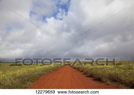 Stock Photo - A vast view of a bright orange dirt road; Lanai, Hawaii, United States of America. Fotosearch