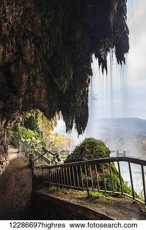 Stock Photograph - A walkway behind a waterfall; Edessa, Greece. Fotosearch