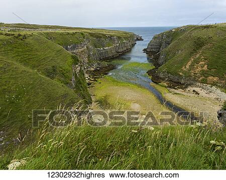 A waterway between the cliffs of the coast leading into a river in the Highlands; Scotland View Large Photo Image Stock Photograph - A waterway between the cliffs of the coast leading into a river in the Highlands; Scotland. Fotosearch