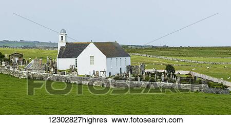 Stock Photograph - A white church and cemetery surrounded by a stone fence; Latheron, Scotland. Fotosearch