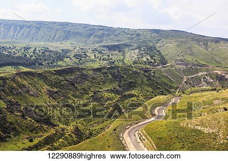 A winding road that makes it's way up and and around the Golan Heights, with remains of a train track bridge built over the Yarmouk river in the distance; Golan Heights, Israel View Large Photo Image Stock Photograph - A winding road that makes it's way up and and around the Golan Heights, with remains of a train track bridge built over the Yarmouk river in the distance; Golan Heights, Israel. Fotosearch