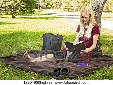 A young woman spending personal time in Bible study in a park during autumn; Edmonton, Alberta, Canada View Large Photo Image Stock Photograph - A young woman spending personal time in Bible study in a park during autumn; Edmonton, Alberta, Canada. Fotosearch