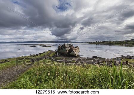 Abandoned boats sinking at the water's edge View Large Photo Image Stock Photography - Abandoned boats sinking at the water's edge. Fotosearch