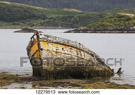 Stock Image - Abandoned wooden boat sinking in the water; Ardfern, Scotland. Fotosearch