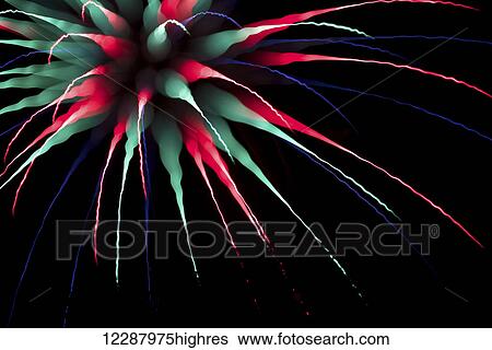 Stock Photograph - Abstract multi-coloured firework burst using focus pull; Twickenham, England. Fotosearch