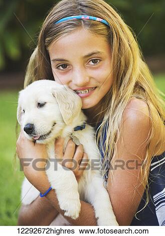 Adorable Cute Young Girl with Golden Retriever Puppy View Large Photo Image Stock Photograph - Adorable Cute Young Girl with Golden Retriever Puppy. Fotosearch