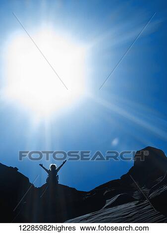 Stock Photograph - Adventurer exploring a desert slot canyon, San Rafael Swell; Utah, United States of America. Fotosearch
