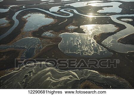Aerial of frozen ponds that surround the meandering Noatak River near Kotzebue, Arctic Alaska View Large Photo Image Stock Photograph - Aerial of frozen ponds that surround the meandering Noatak River near Kotzebue, Arctic Alaska. Fotosearch