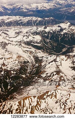 Aerial perspective of glaciers, fjords, and snow-covered moutains in the Aleutian Range, Alaska Peninsula, Southwestern Alaska, USA, Summer View Large Photo Image Stock Photo - Aerial perspective of glaciers, fjords, and snow-covered moutains in the Aleutian Range, Alaska Peninsula, Southwestern Alaska, USA, Summer. Fotosearch