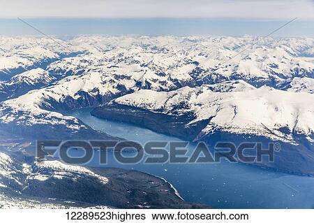 Aerial view of a glacier fjord in the Inside Passage, and snow capped peaks, Wrangell, Southeast Alaska, USA, Spring View Large Photo Image Stock Photograph - Aerial view of a glacier fjord in the Inside Passage, and snow capped peaks, Wrangell, Southeast Alaska, USA, Spring. Fotosearch