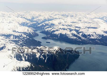 Aerial view of a glacier fjord in the Inside Passage, and snow capped peaks, Wrangell, Southeast Alaska, USA, Spring View Large Photo Image Stock Photograph - Aerial view of a glacier fjord in the Inside Passage, and snow capped peaks, Wrangell, Southeast Alaska, USA, Spring. Fotosearch