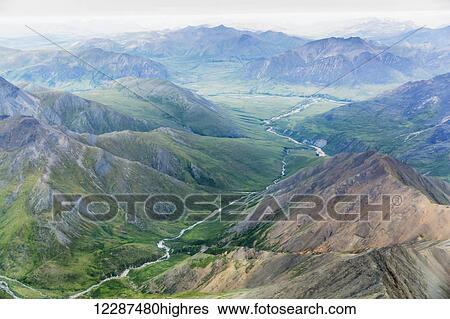 Stock Photograph - Aerial view of a river cutting through a valley in the Brooks Range; Alaska, United States of America. Fotosearch