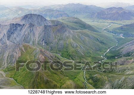 Stock Photograph - Aerial view of a river cutting through a valley in the Brooks Range; Alaska, United States of America. Fotosearch