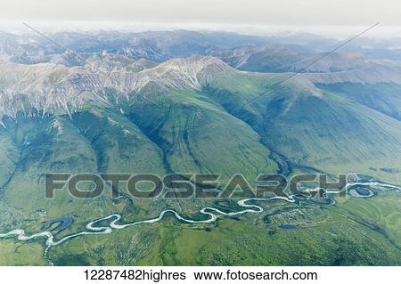 Stock Photograph - Aerial view of a river cutting through a valley in the Brooks Range; Alaska, United States of America. Fotosearch