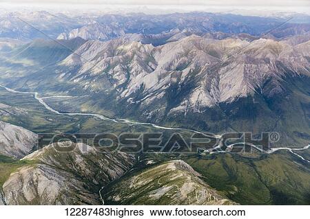Stock Photograph - Aerial view of a river cutting through a valley in the Brooks Range; Alaska, United States of America. Fotosearch