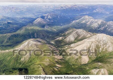 Stock Photograph - Aerial view of a river cutting through a valley in the Brooks Range; Alaska, United States of America. Fotosearch