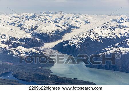 Aerial view of a tidewater glacier in the Inside Passage, and snow capped peaks, Wrangell, Southeast Alaska, USA, Spring View Large Photo Image Stock Photograph - Aerial view of a tidewater glacier in the Inside Passage, and snow capped peaks, Wrangell, Southeast Alaska, USA, Spring. Fotosearch