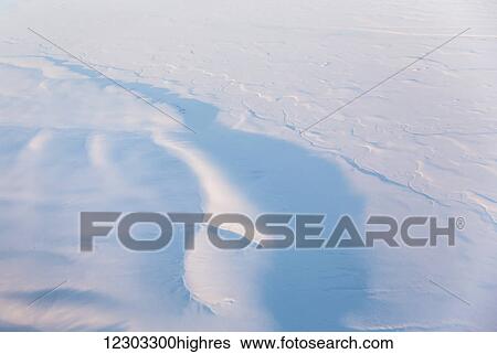 Aerial view of snow covered hills casting shadows during sunset, North Slope, Arctic Alaska, USA, Winter View Large Photo Image Stock Photograph - Aerial view of snow covered hills casting shadows during sunset, North Slope, Arctic Alaska, USA, Winter. Fotosearch