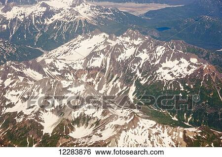Aerial view of snow-covered mountains and bare rock peaks of the Aleutian Range, Alaska Peninsula, Southwestern Alaska, USA, Summer View Large Photo Image Stock Photograph - Aerial view of snow-covered mountains and bare rock peaks of the Aleutian Range, Alaska Peninsula, Southwestern Alaska, USA, Summer. Fotosearch