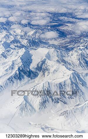 Stock Photograph - Aerial view of snow covered mountains near Anchorage, Southcentral Alaska, USA, Spring. Fotosearch