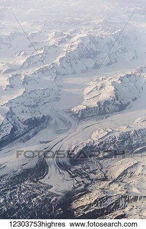 Stock Photograph - Aerial view of snow covered mountains and glaciers in the coastal range, Southeast Alaska; Alaska, United States of America. Fotosearch