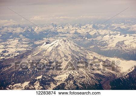 Picture - Aerial view of snow-covered Mt. Iliamna and surrounding mountains of the Aleutian Range, Alaska Peninsula, Southwestern Alaska, USA, Summer. Fotosearch