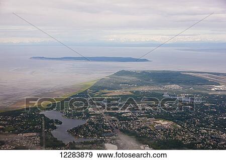 Stock Photo - Aerial view of the Sand Lake Neighborhood of Anchorage, Fire Island, Kincaid Park, and the Anchorage International Airport visible in the background, Southcentral Alaska, USA, Summer. Fotosearch